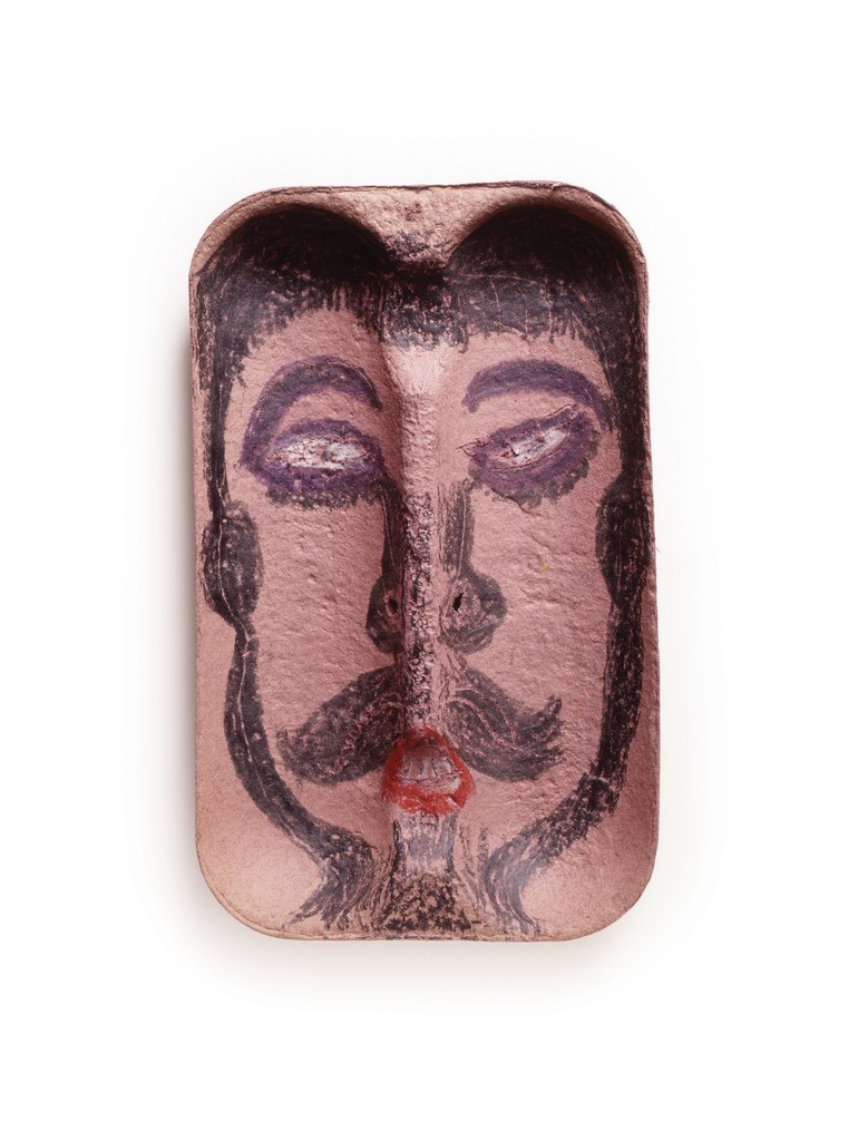 Pink, textured fruit carton with a drawing of a distorted face, outlined in black crayon, that has a thick handlebar mustache and small red mouth shaped into an O.