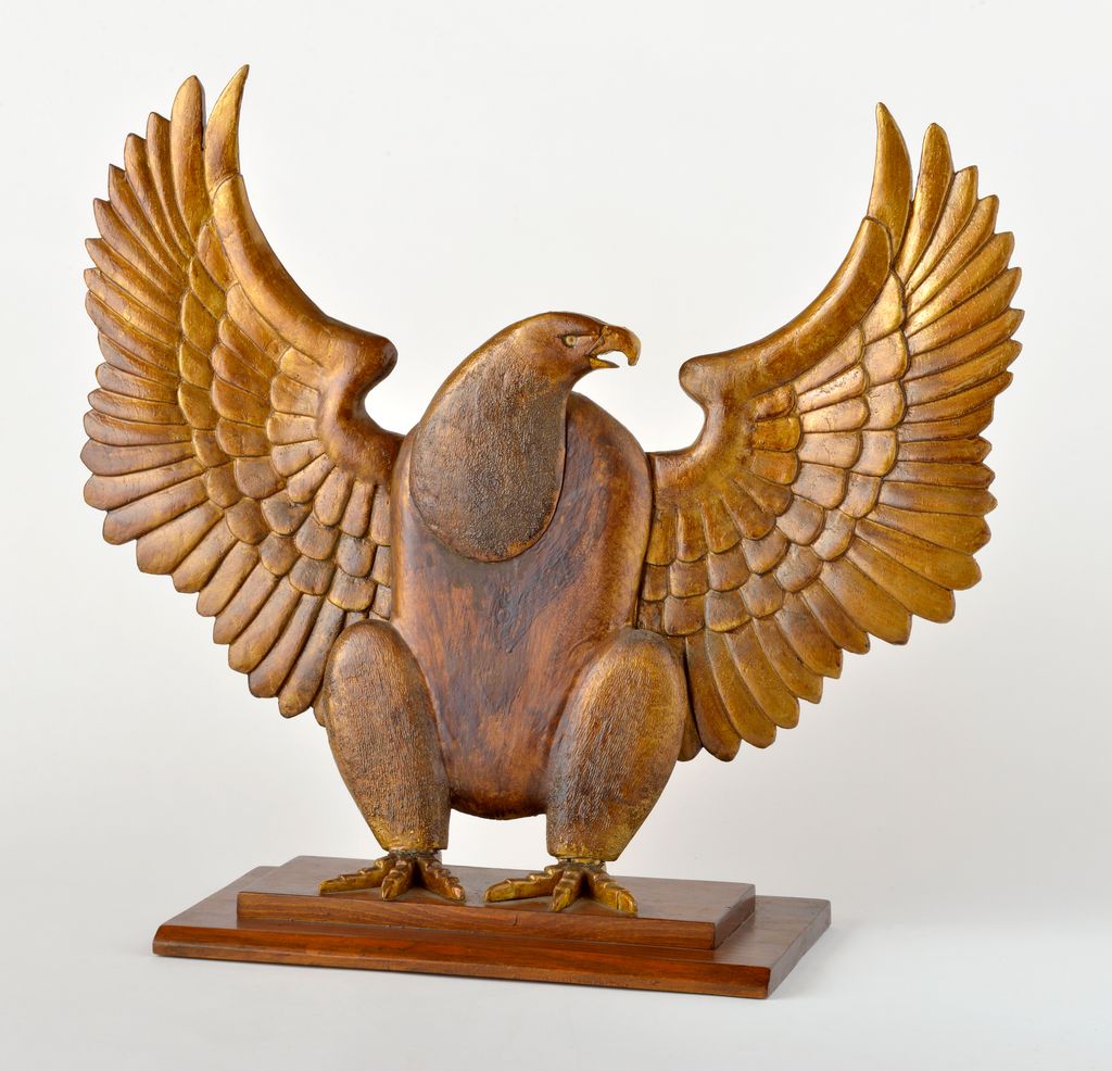 American carved wooden gilded eagle with outstretched wings on stepped rectangular stand