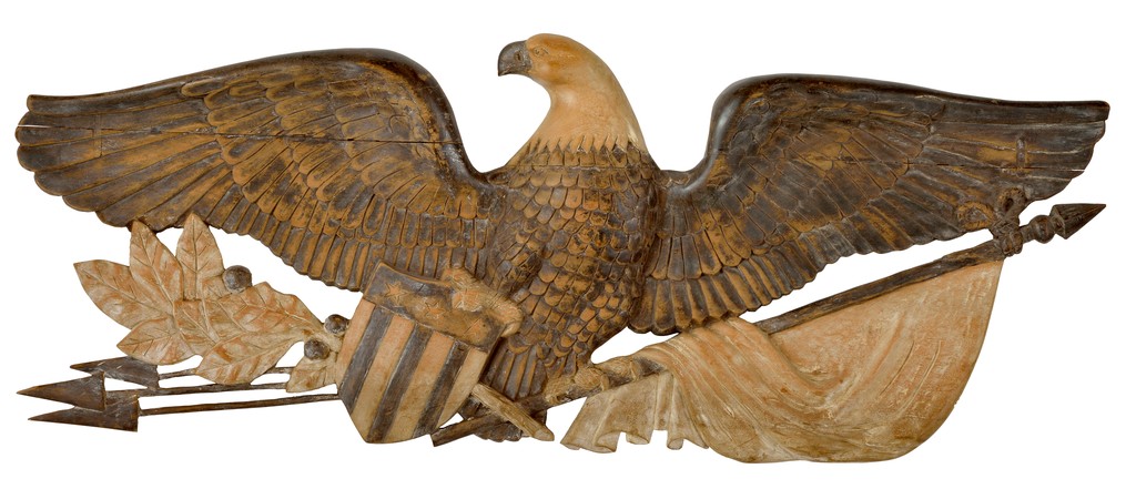 American polychrome carved wooden eagle on arrows holding shield, flag and oak leaves in talons