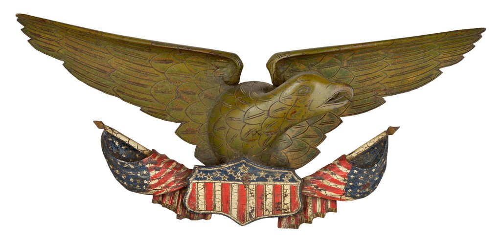American polychrome carved wooden eagle with outspread wings having furled flags flanking American shield below