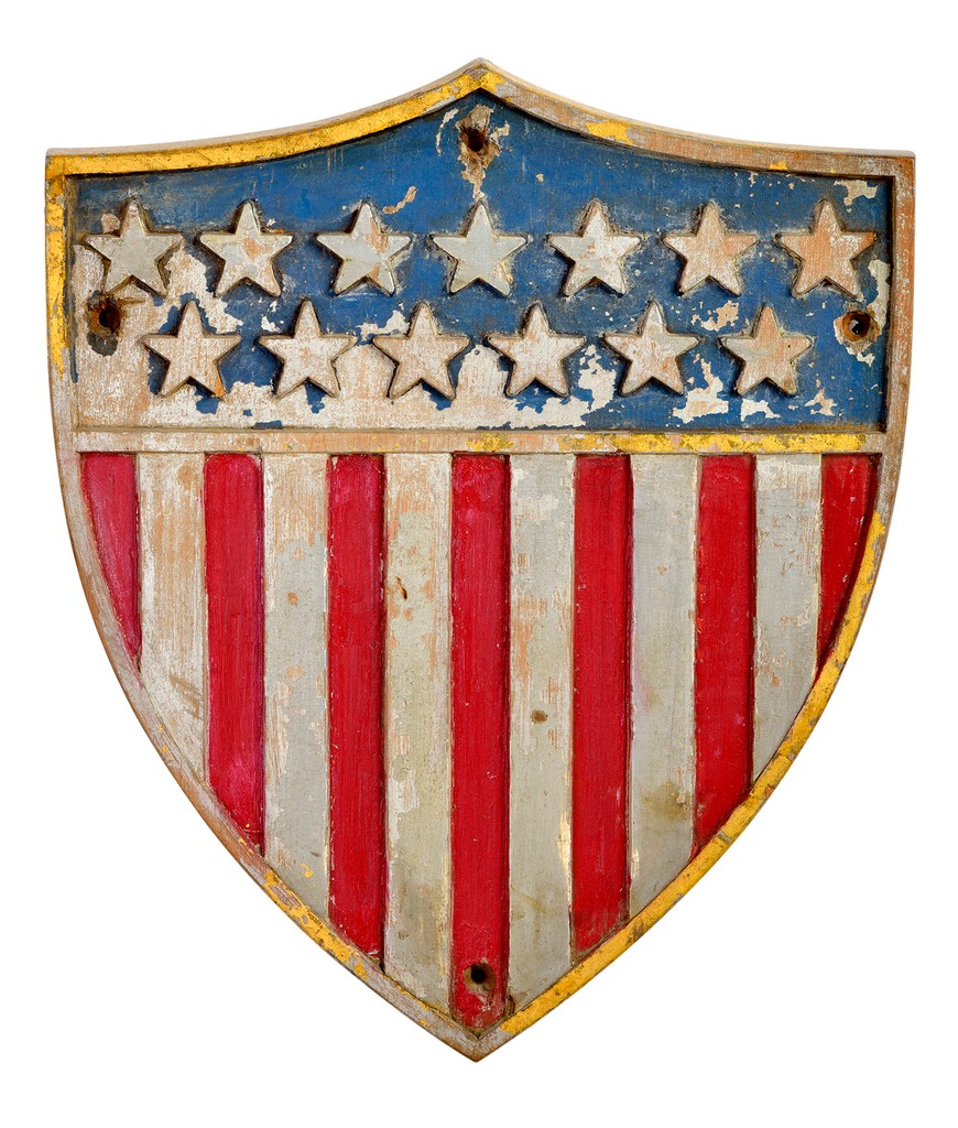 American polychrome relief carved oak wooden shield with thirteen stars on blue ground with red and silver stripes below and gilt enrichment