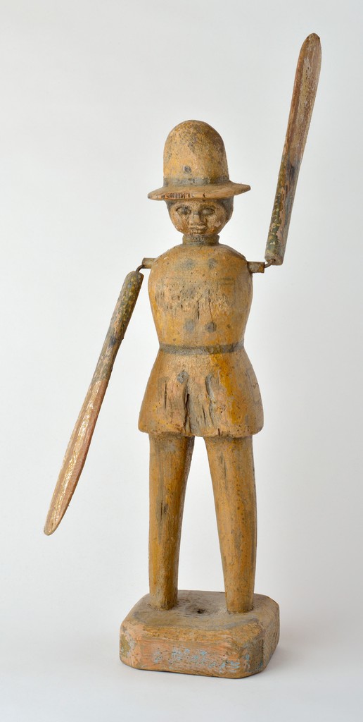 American polychrome carved wooden figural policeman whirligig with two faces on wooden base