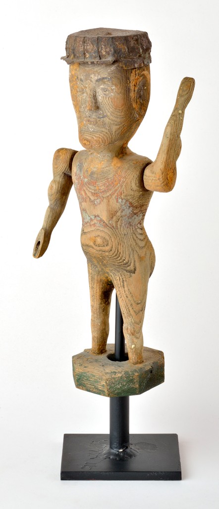 American carved wooden figural man whirligig wearing tin hat with traces of paint on wooden stand on metal base