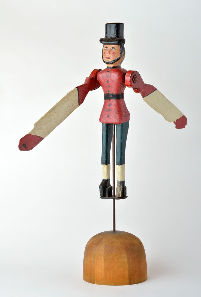 American polychrome carved wooden figural man whirligig wearing top hat on domed base, damage to left foot