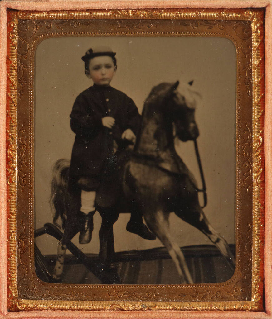 Portrait of a Young Boy on Rocking Horse